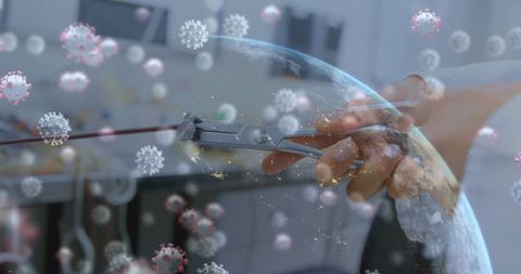 Hand Manipulating Wire with Virus Cells and Globe Light Effects - Download Free Stock Images Pikwizard.com