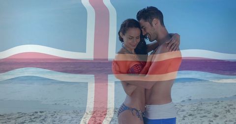Romantic couple embraces on sunny beach with icelandic flag
