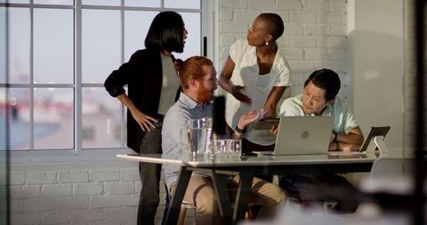 Diverse team engaged in intense office discussion