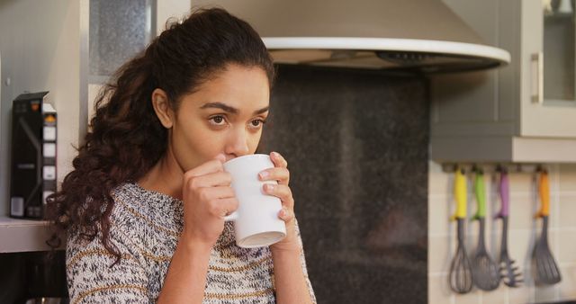 Young Woman Enjoying Hot Drink in Modern Kitchen - Download Free Stock Images Pikwizard.com