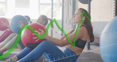Women Training in Gym as Fitness Data Graph Overlays Their Exercise