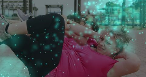 Women Exercising at Outdoor Fitness Course with Dynamic Light Visuals