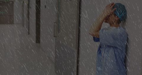 Stressed Nurse in Hospital Corridor