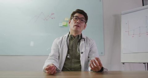 Confident doctor explaining data insights at modern clinic