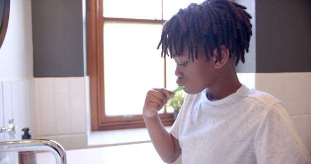 African American Boy Brushing Teeth in Bathroom - Download Free Stock Images Pikwizard.com