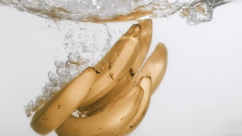 Bananas Splashing into Water in Slow Motion