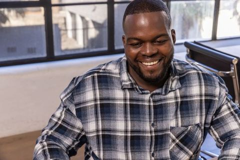 Smiling Professional Sitting in Modern Office