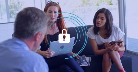 Business Professionals Collaborating in Office Lounge with Technology