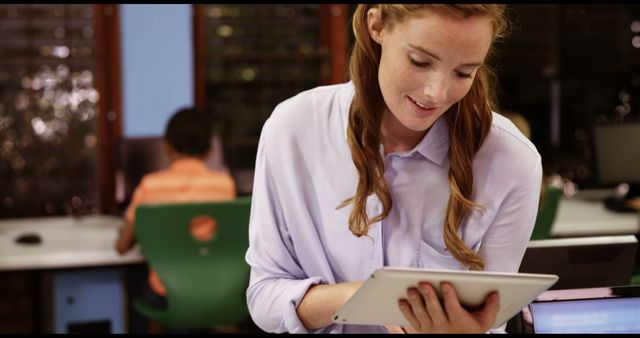 Smiling Woman Using Digital Tablet in Office Environment - Download Free Stock Images Pikwizard.com