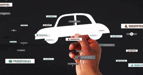 Hand holding paper car cutout with floating data tags showing connected vehicle concept