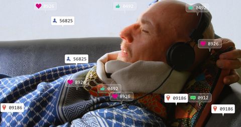 Caucasian Man Relaxing at Home With Social Media Engagement Icons