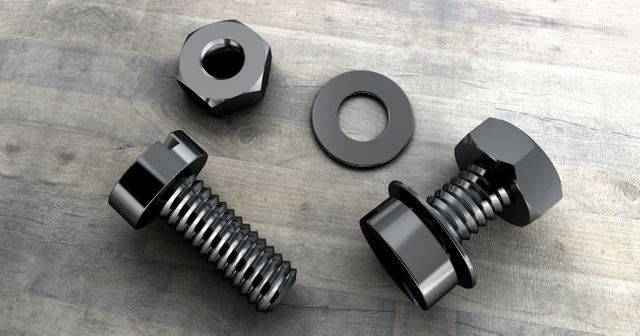 Shiny metal nuts, bolts, and washers arranged on a weathered wooden surface. Ideal for use in industrial and construction contexts, tool workshops, or hardware stores. Perfect for promotional material related to manufacturing, engineering, or DIY projects.