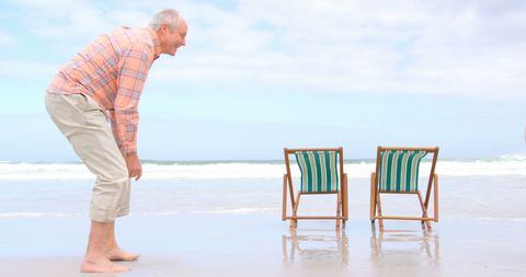 Senior Couple Enjoying Relaxing Day at the Beach - Download Free Stock Images Pikwizard.com