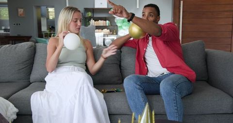 Couple Decorating Room for House Party with Balloons