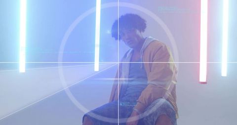 Man in Neon-Lit Studio with Grid Overlay in Modern Urban Setting