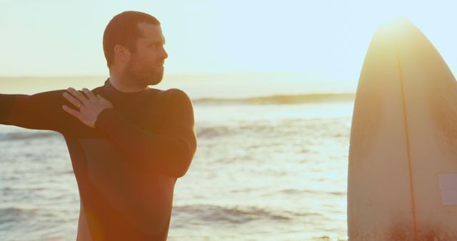 Male Surfer Stretching by Ocean at Sunrise - Download Free Stock Images Pikwizard.com