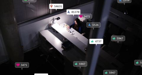 Woman working late on laptop at office desk with social media overlays and moody lighting