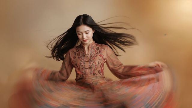 Spinning model wearing embroidered bohemian dress with voluminous swirling skirt motion