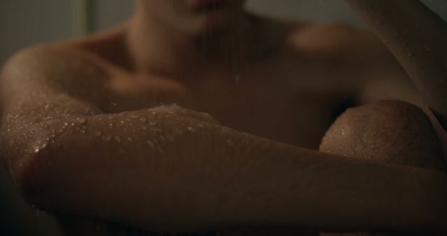 Person sitting in shower with water droplets on skin - Download Free Stock Images Pikwizard.com