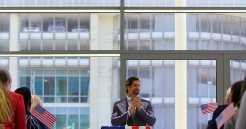 Confident business leader receiving applause at seminar