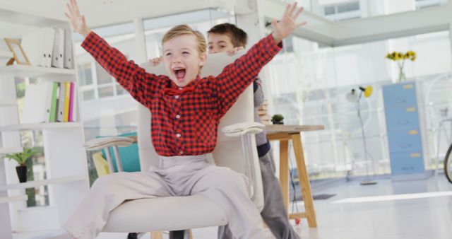 Children Playing in Office on Rolling Chair - Download Free Stock Images Pikwizard.com