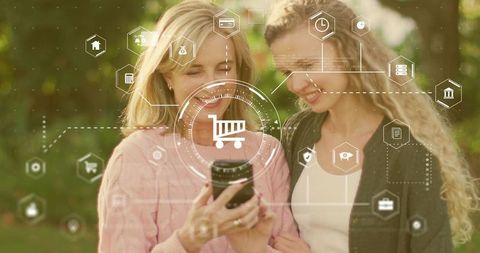 Two Women Sharing Smartphone While Browsing Augmented Shopping Interface in Park