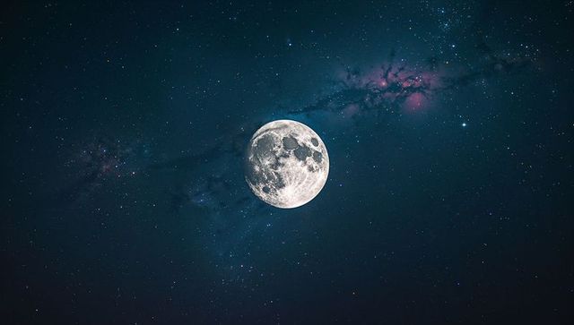 Full Moon Illuminating Starry Night Sky with Nebula