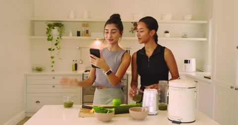 Diverse Friends Making Green Juice in Modern Kitchen for Health and Wellness