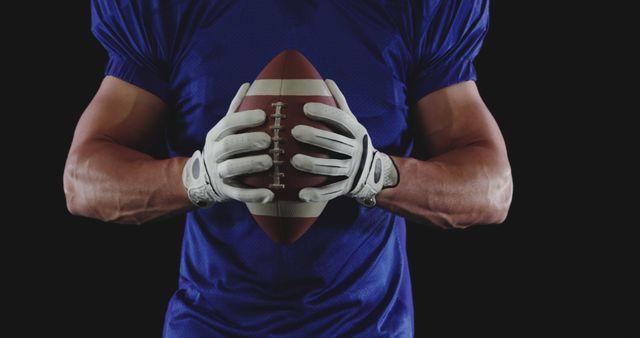 Football Player Holding Ball in Blue Jersey - Download Free Stock Images Pikwizard.com