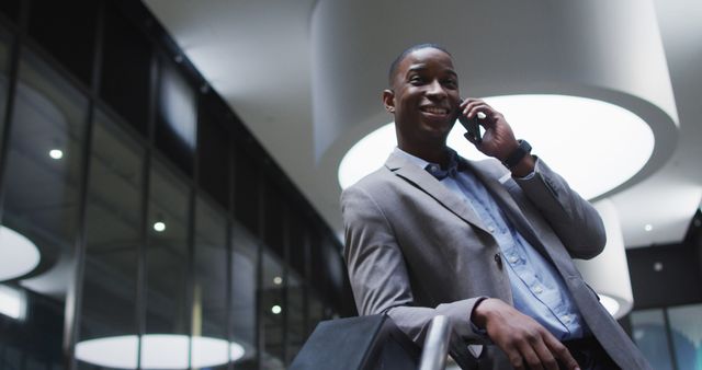 Confident Businessman Making Phone Call in Office Lobby - Download Free Stock Images Pikwizard.com