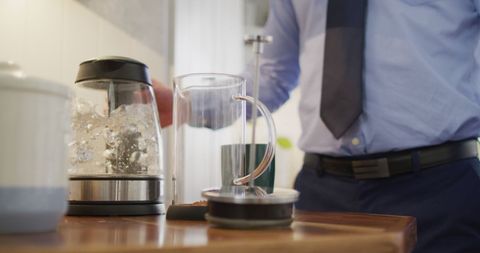 Businessperson Preparing Coffee in Modern Kitchen