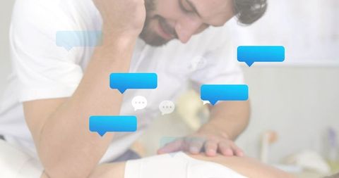 Male therapist leaning and pressing back during massage with chat bubbles for wellness