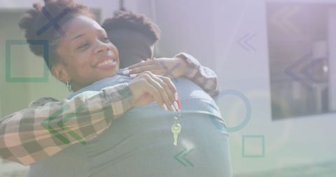 Joyful Couple Embracing with New House Keys