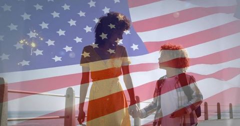 Mother and Child Holding Hands on Sunlit Seaside Promenade with American Flag Double Exposure