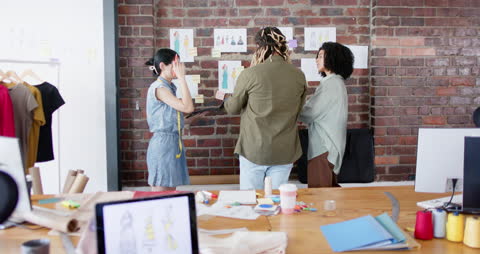 Creative Team Discussing Fashion Design Concepts in Modern Office