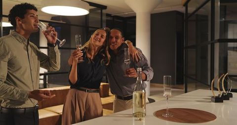 Diverse Colleagues Toasting Success in Modern Office Environment