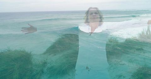Woman embracing waves in double exposure landscape