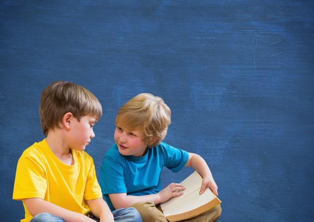 Cute kids reading books against blue background