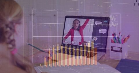 Child writing while teacher raising hand on laptop with analytics overlay for tutoring