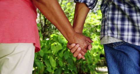 Senior Couple Holding Hands in Peaceful Garden
