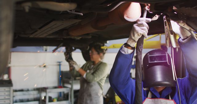 Professional Auto Mechanics Working on Car Repair in Garage - Download Free Stock Images Pikwizard.com