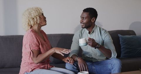 Friends Enjoying Coffee and Laughter in Cozy Setting