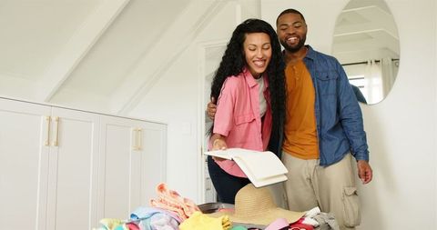 Couple Packing for Vacation in Cozy Home Setting