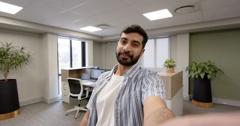 Young Professional Taking Selfie in Modern Corporate Office