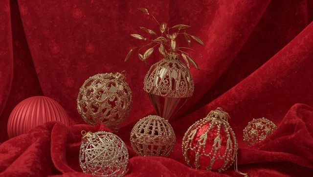 Luxurious gold filigree christmas baubles on red velvet