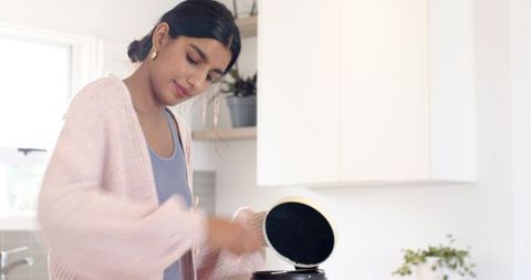 Woman Checking Rice Cooker on Modern Kitchen Counter