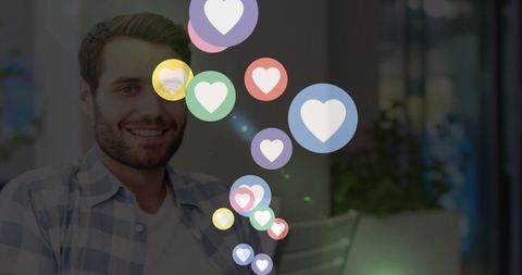 Man interacting with social media heart icons at home