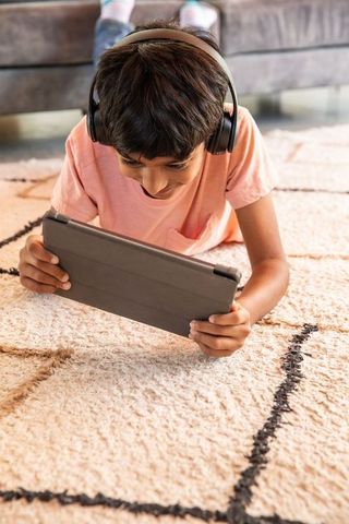 Boy enjoying tablet time on living room floor