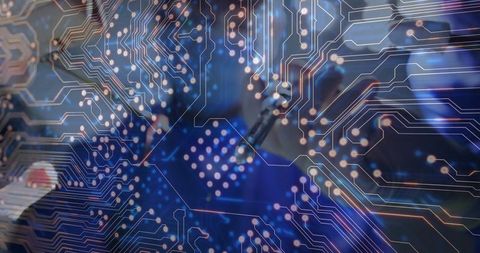 Technician soldering pcb with digital circuit overlay