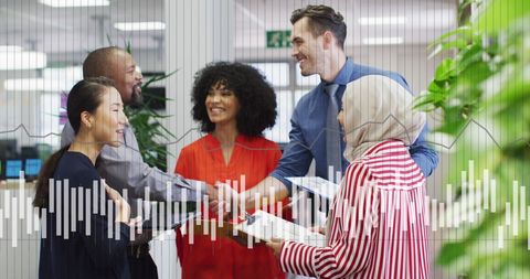 Diverse Business Team and Financial Data Overlay in Modern Office